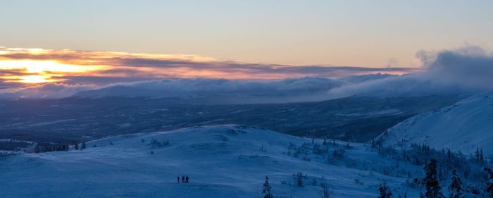 Scenic view of snowcapped mountain against sky during sunset