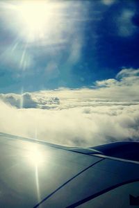 Aerial view of airplane wing against sky