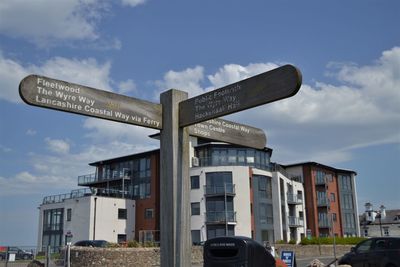 Low angle view of road sign against sky