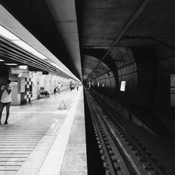 People waiting at railroad station platform