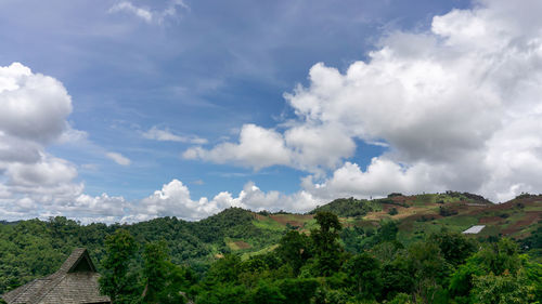 Beautiful view white fluffy clouds on vivid blue sky above greenery mountain