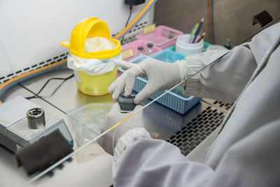 Midsection of scientist working in laboratory