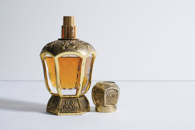 Close-up of glass bottle on table against white background