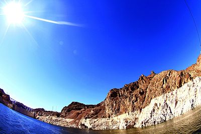 Low angle view of mountain against blue sky