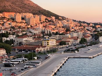 High angle view of townscape by sea against sky