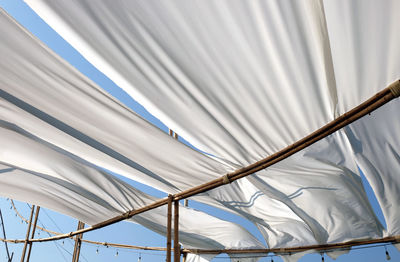 Low angle view of metal railing against sky