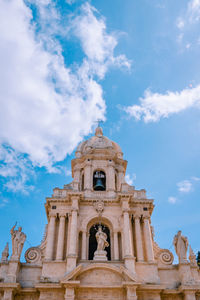 Church facade church of san bartolomeo in scicli with blue sky and white clouds