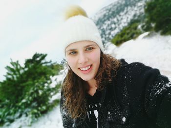 Portrait of smiling young woman during winter