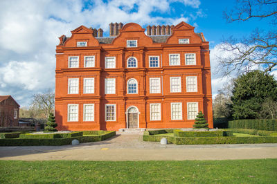 Facade of house against cloudy sky