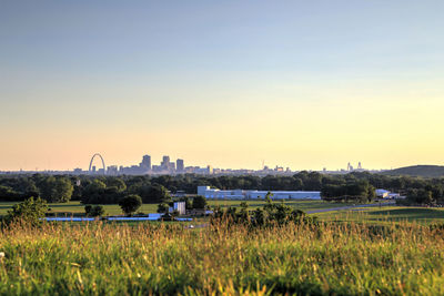 Scenic view of field against clear sky during sunset