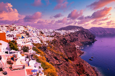 High angle view of townscape by sea against sky