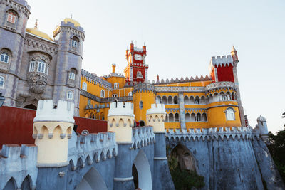 Ancient castle with bright colorful walls located against cloudless evening sky in portugal