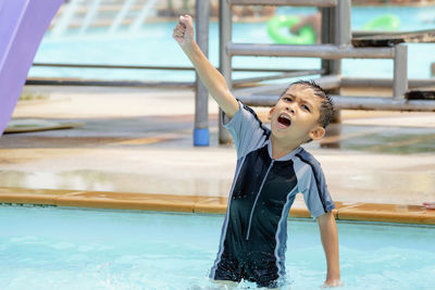 Asian boy in swimwear, swimming fun in the pool.