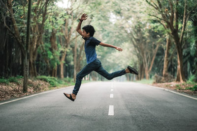 Full length of man jumping on road