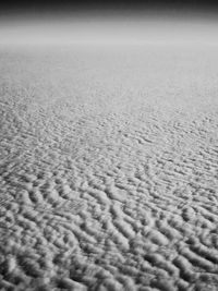 Close-up of sand on beach against sky