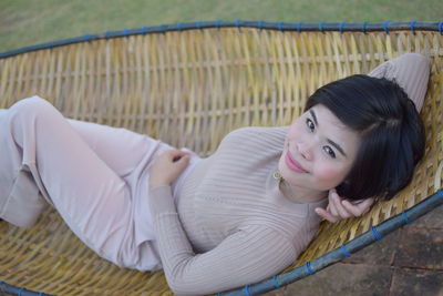 Portrait of a smiling young woman lying down