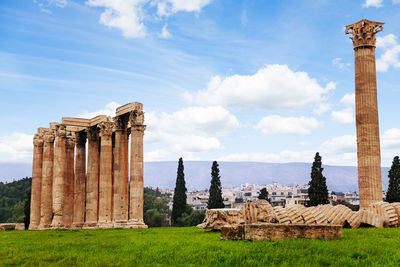 Ruins of temple against cloudy sky