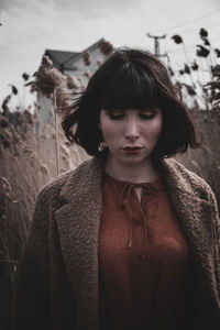 Portrait of young woman standing outdoors