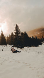 Scenic view of snow covered field against sky
