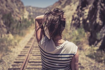 Rear view of woman standing at bus