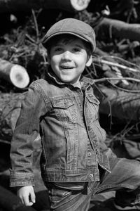 Happy boy looking away while standing outdoors