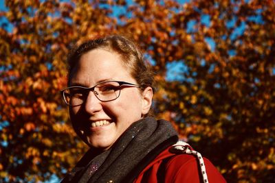 Portrait of smiling woman against trees during autumn