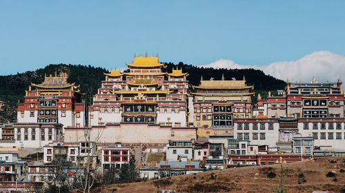 Buildings in city against sky