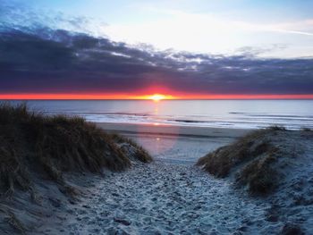 Scenic view of beach against sky during sunset