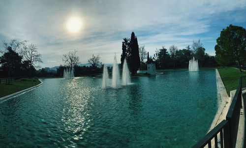 View of swimming pool in lake against cloudy sky