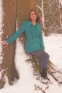 Portrait of young woman standing in snow