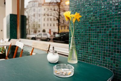 Vase with ash tray and salt shaker on restaurant table