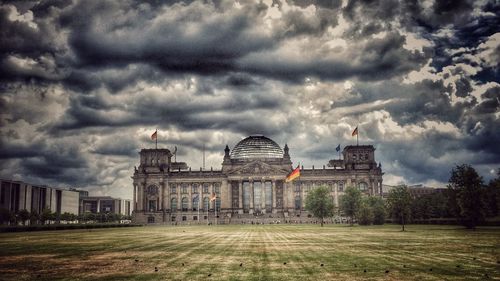 Facade of palace against cloudy sky