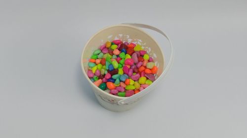 High angle view of multi colored candies against white background