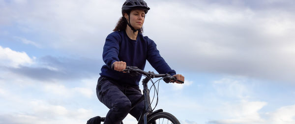 Low angle view of man riding bicycle