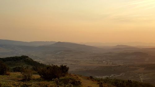 Scenic view of mountains against sky at sunset