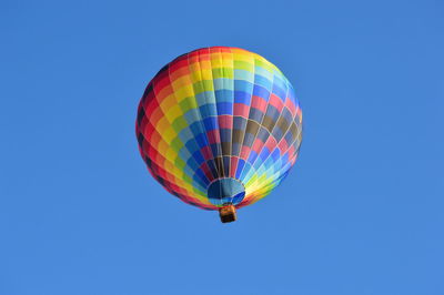 Low angle view of hot air balloon against blue sky