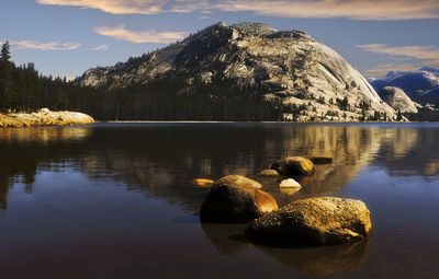 Scenic view of lake by mountain against sky