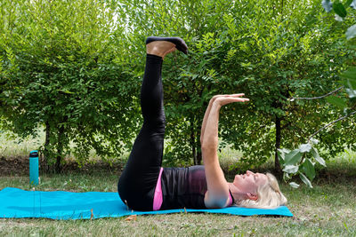Rear view of woman exercising in park