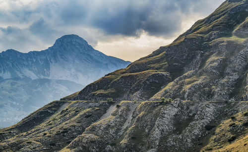 Mountain side with barely visible road. picture is captured in montenegro, durmitor national park