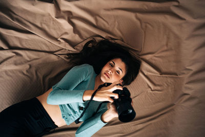 High angle view of woman lying on bed