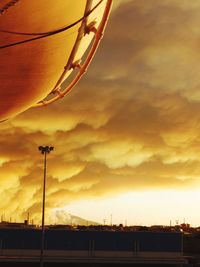 Low angle view of silhouette bridge against dramatic sky