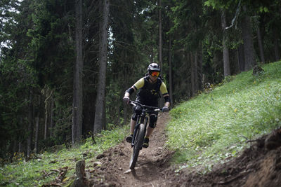 Man riding bicycle in forest