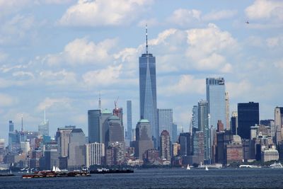 View of skyscrapers against cloudy sky