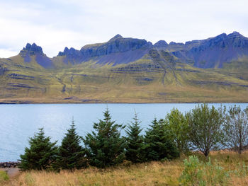 Scenic view of lake and mountains against sky