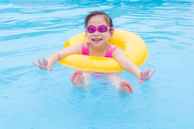 Portrait of smiling girl swimming in pool