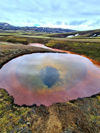 Scenic view of lake against cloudy sky