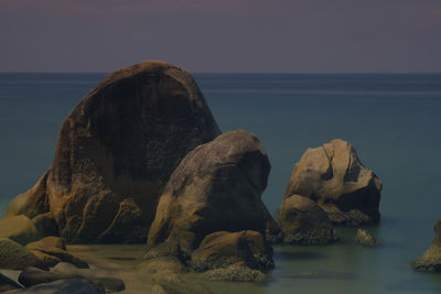 View of rock formation on beach against sky