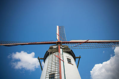 Low angle view of windmill against sky