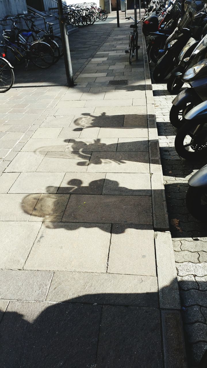 LOW SECTION OF SHADOW ON COBBLESTONE