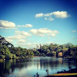 Scenic view of calm lake against cloudy sky